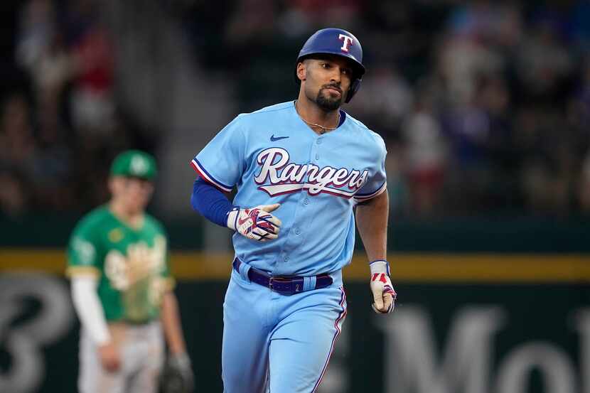 Texas Rangers' Marcus Semien rounds the bases after hitting a solo home run in the sixth...
