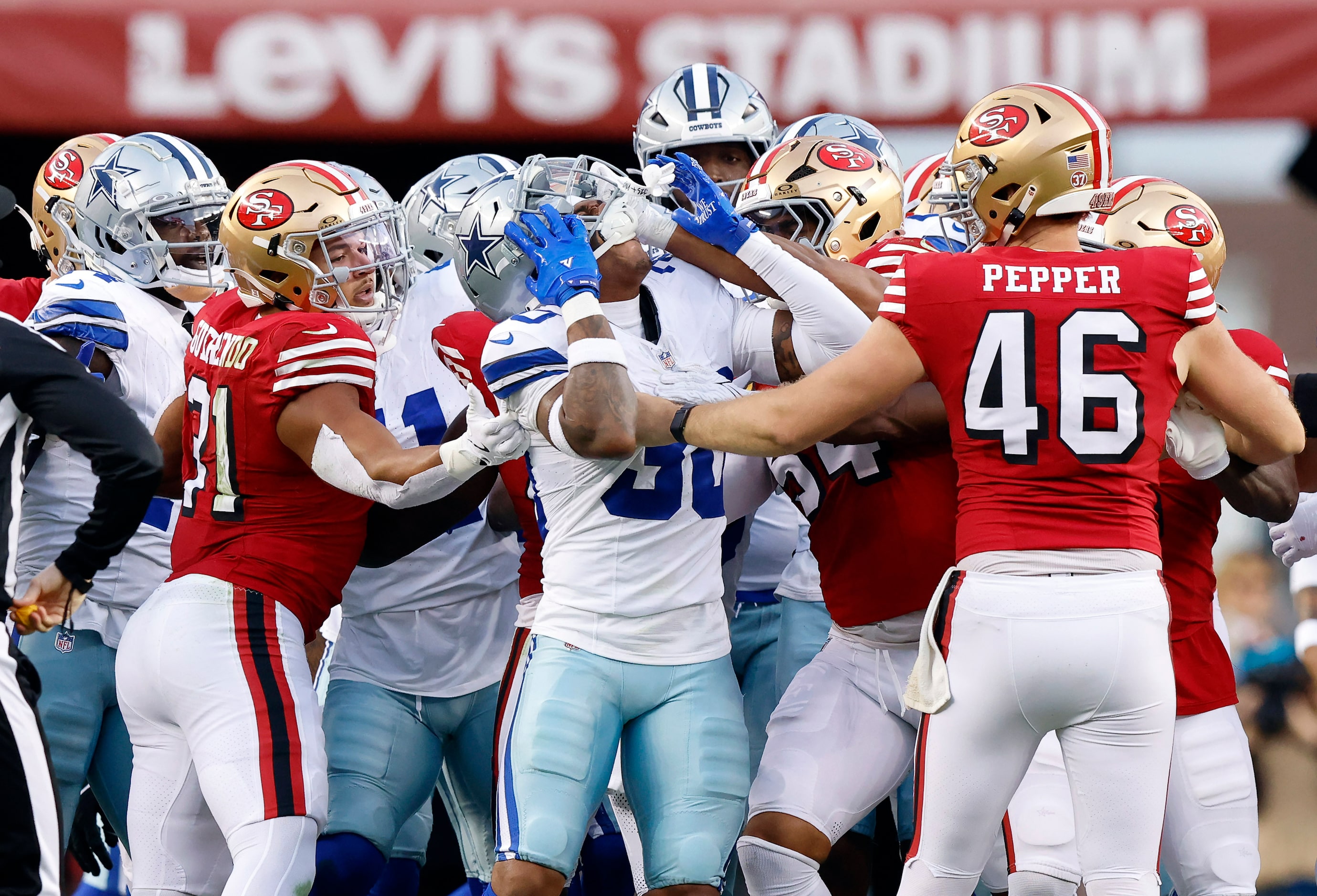 San Francisco 49ers linebacker Fred Warner (54) shoves Dallas Cowboys safety Juanyeh Thomas...