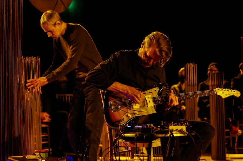 Nels Cline (right) plays guitar as Ben Monder interacts with a sounding sculpture by Harry...