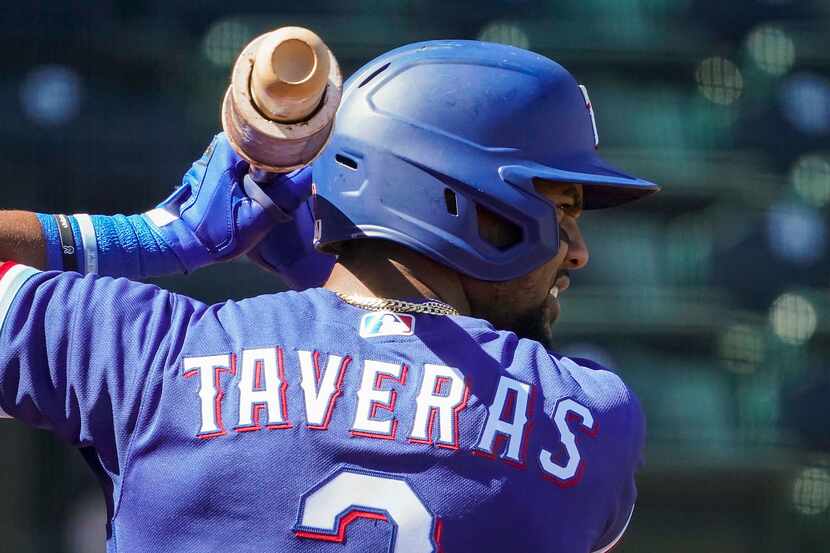 Texas Rangers outfielder Leody Taveras takes a practice swing in the on deck circle before...