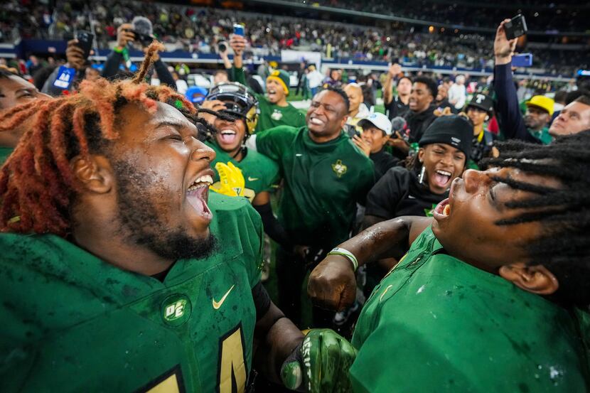 DeSoto defensive tackle Ryan White (left) celebrates with his teammates after a victory over...