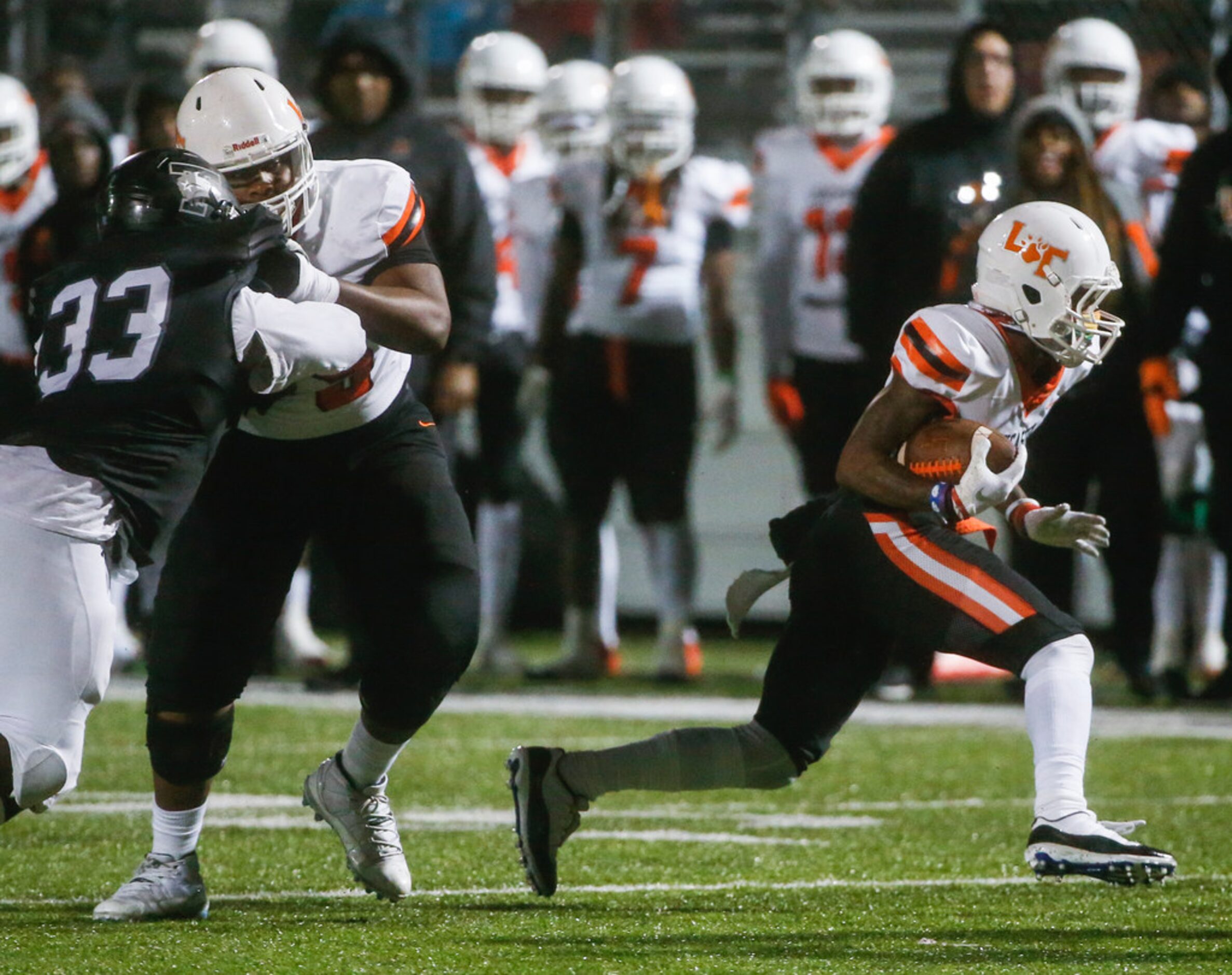 Lancaster wide receiver Majik Rector (5) makes a run during a high school football matchup...