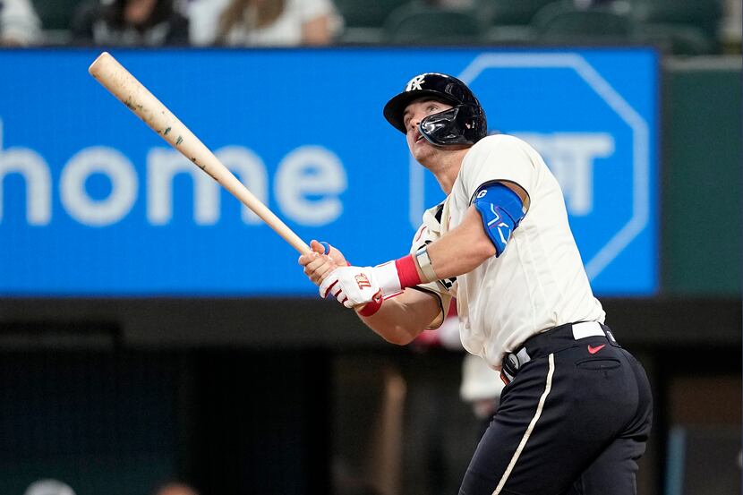 Texas Rangers' Josh Jung follows through on a two-run home run swing that came off a pitch...