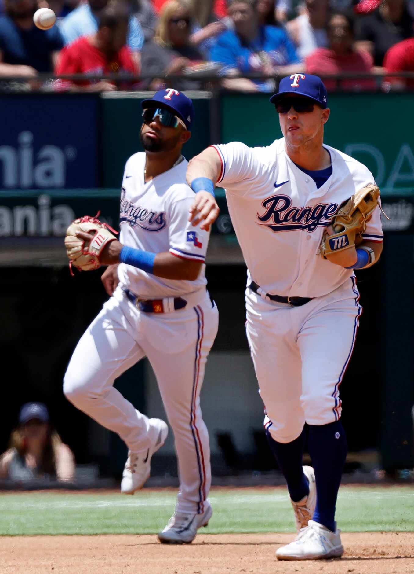 Texas Rangers third baseman Josh Jung (6) fields a hit and throws to first to get Arizona...