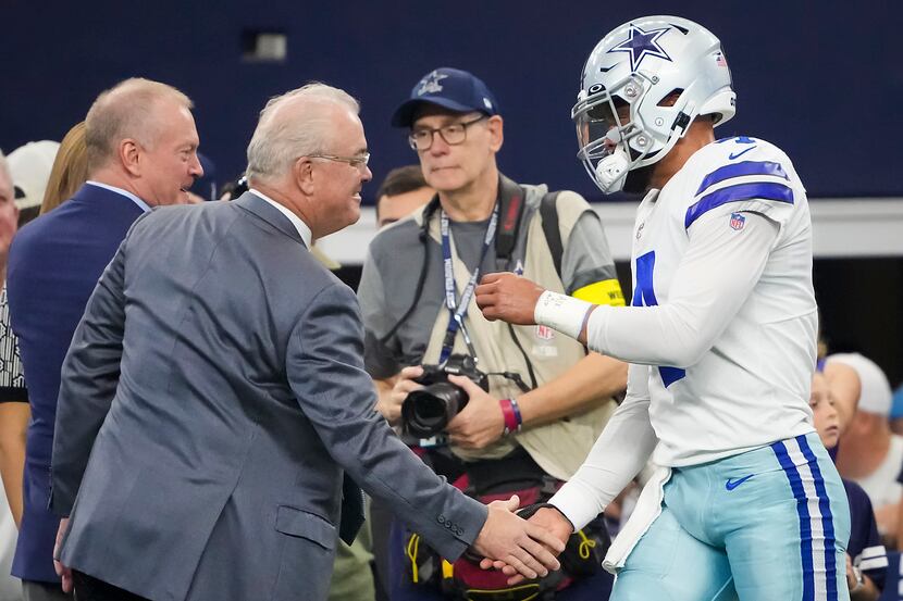 Dallas Cowboys quarterback Dak Prescott shakes hands with Cowboys executive vice president...