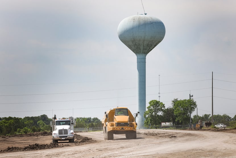 A road construction water-spraying vehicle drove May 18, 2022, near the site where four...