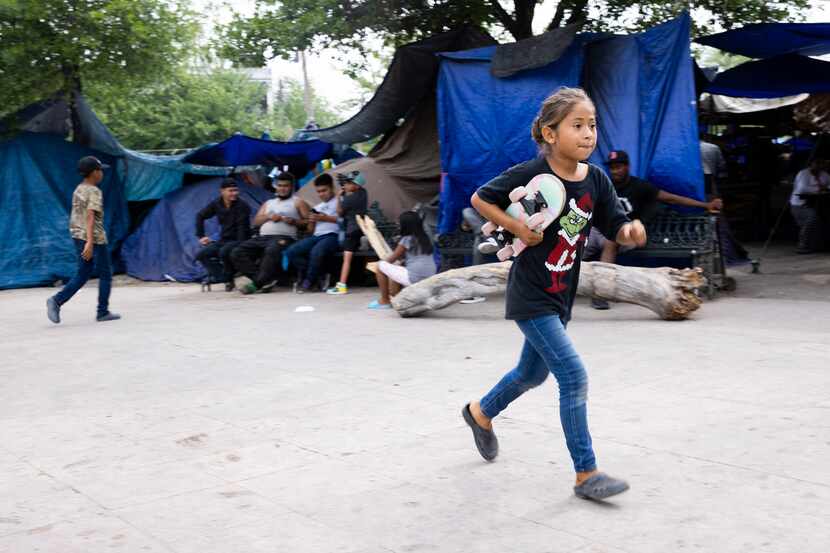 Nohemi Guerra, 8, runs to her mother at Plaza de la República, a public square that's now a...