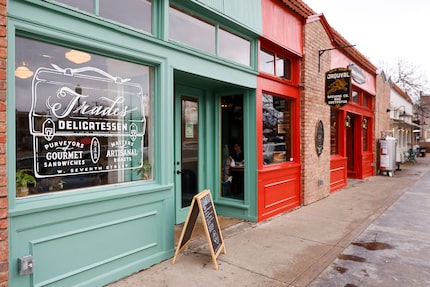 Trades Delicatessen in the Bishop Arts District is in green. Next door, the red shop is...