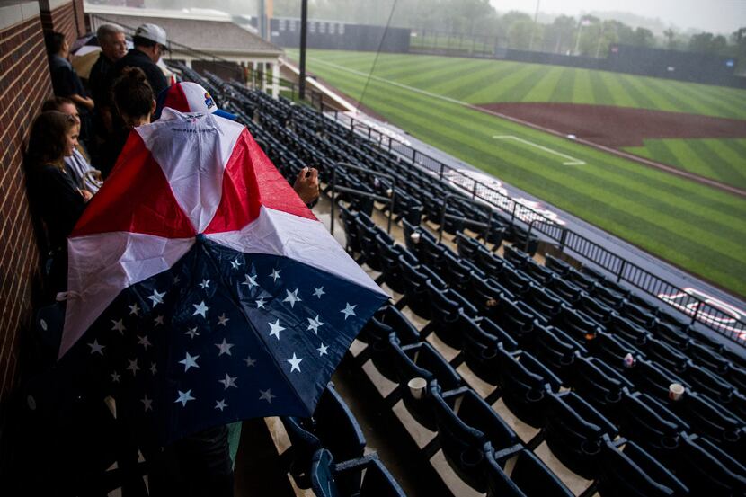 Fans wait out a weather delay during the UIL baseball regional finals on Friday, June 2,...