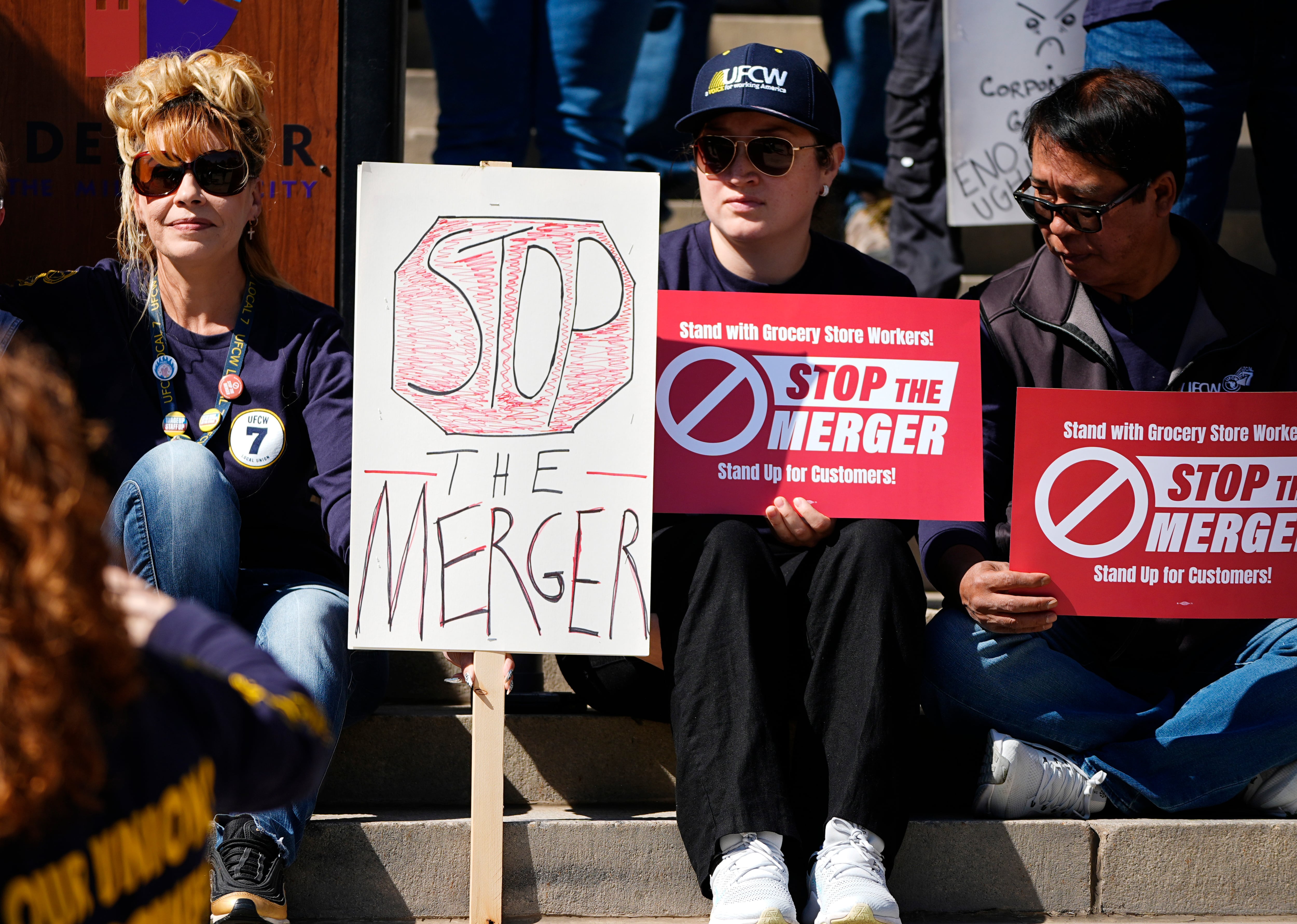 Jozette Leal, left, holds a placard as the 20-year-veteran of toiling at Safeway joins...