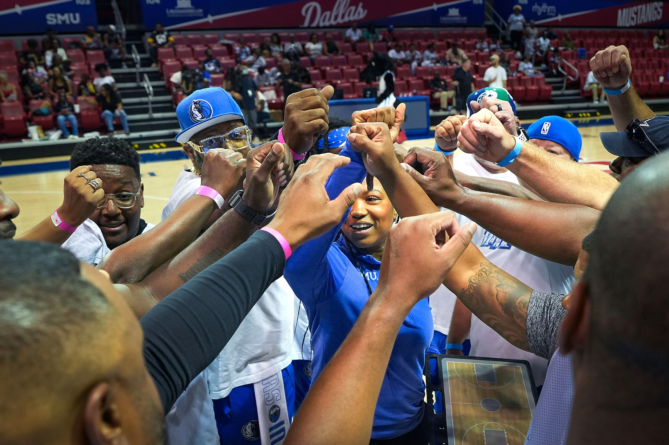 The white team gathers around SMU women’s basketball coach Toyelle Wilson before the 8th...