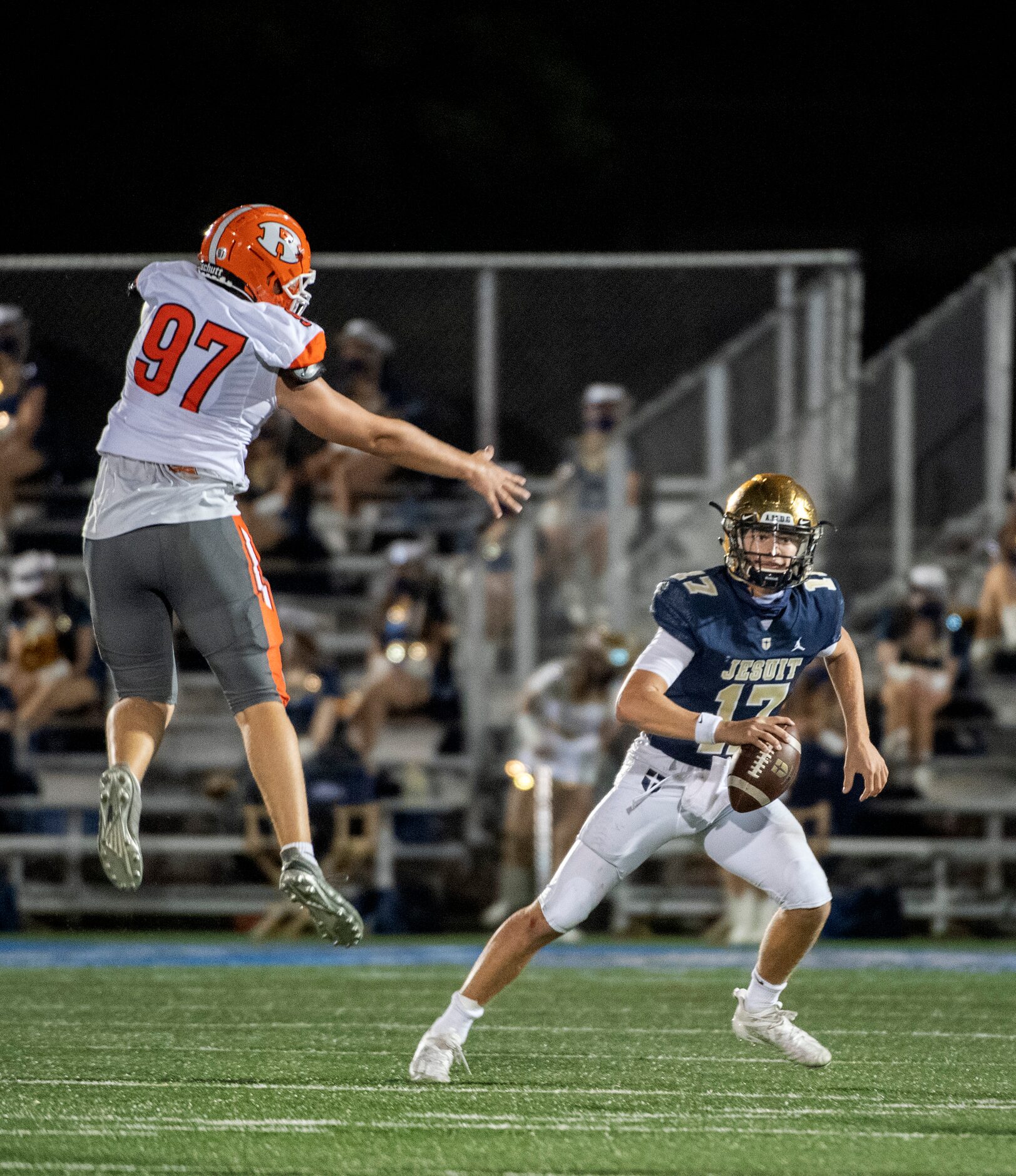 Jesuit junior quarterback Gage Roy (17) looks to pass as Rockwall senior defensive end Jack...