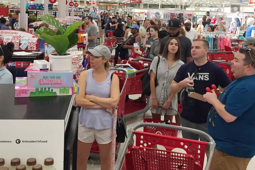Target customers stand in long lines at the store on North Haskell Ave on Saturday afternoon...