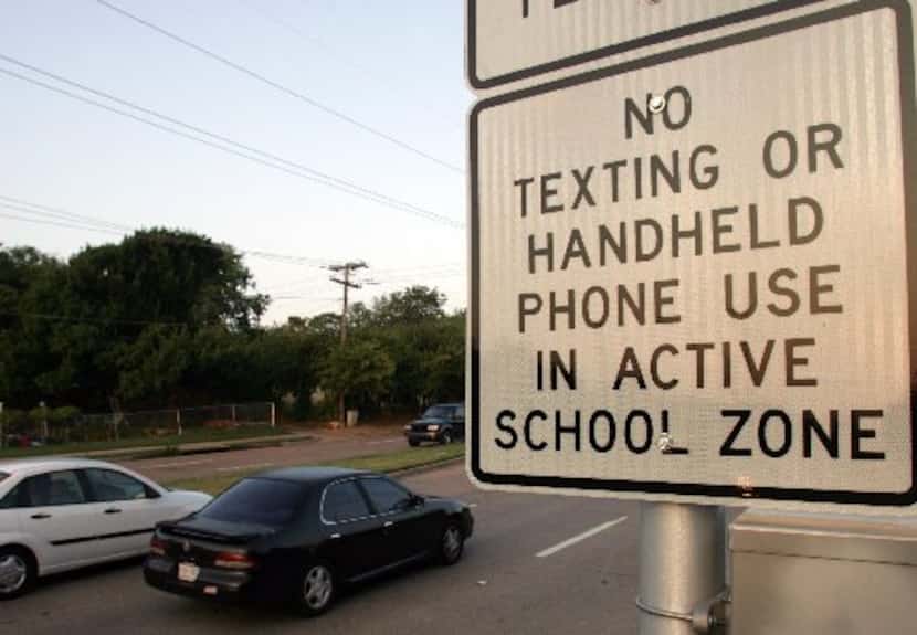 Cars pass through a school zone at Camp Wisdom Road and Wilcox Drive in Dallas. A state law...