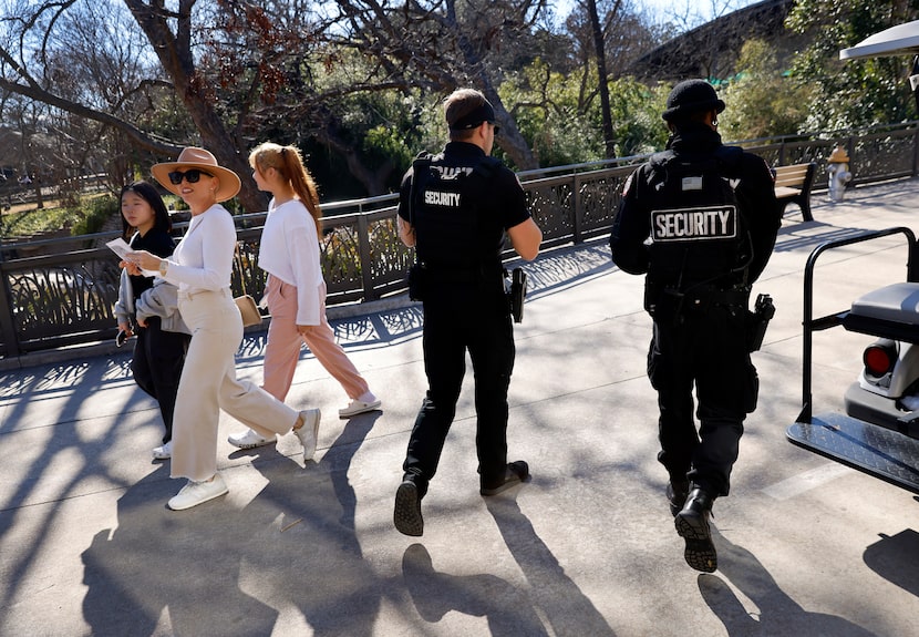 Security officers Darius Walker (right) and Justin Powell patrol the grounds of the Dallas...