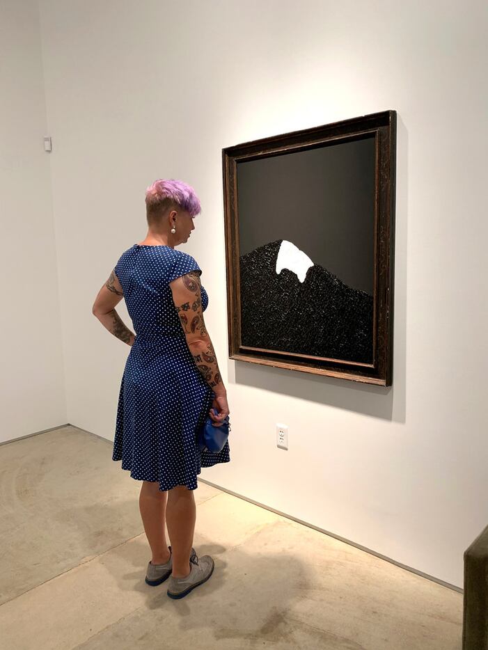 A patron looks at Oshay Green's work 'Mother's Day', 2019, oil on canvas, repurposed Raoul...
