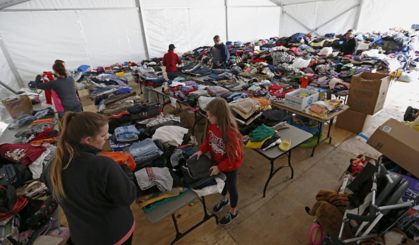 Volunteers set up to receive donations for victims of the December 2015 tornado in the annex...