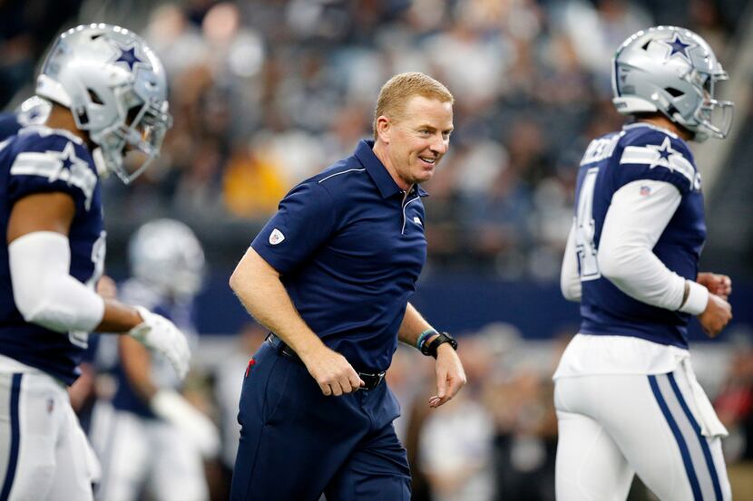 Dallas Cowboys head coach Jason Garrett leads his team down the field during pregame warmups...