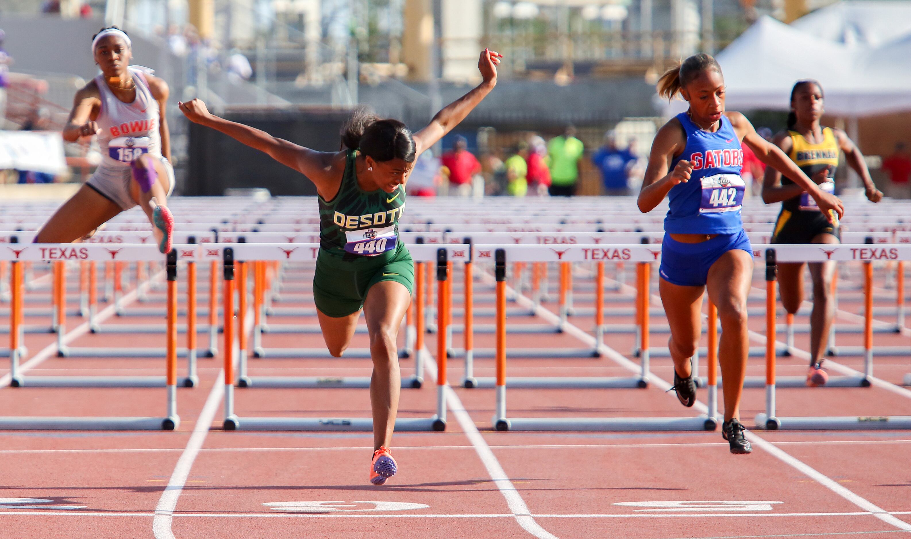 DeSoto's Jalaysi'ya Smith crosses the finish line in the 6A Girls 100 meter hurdles during...