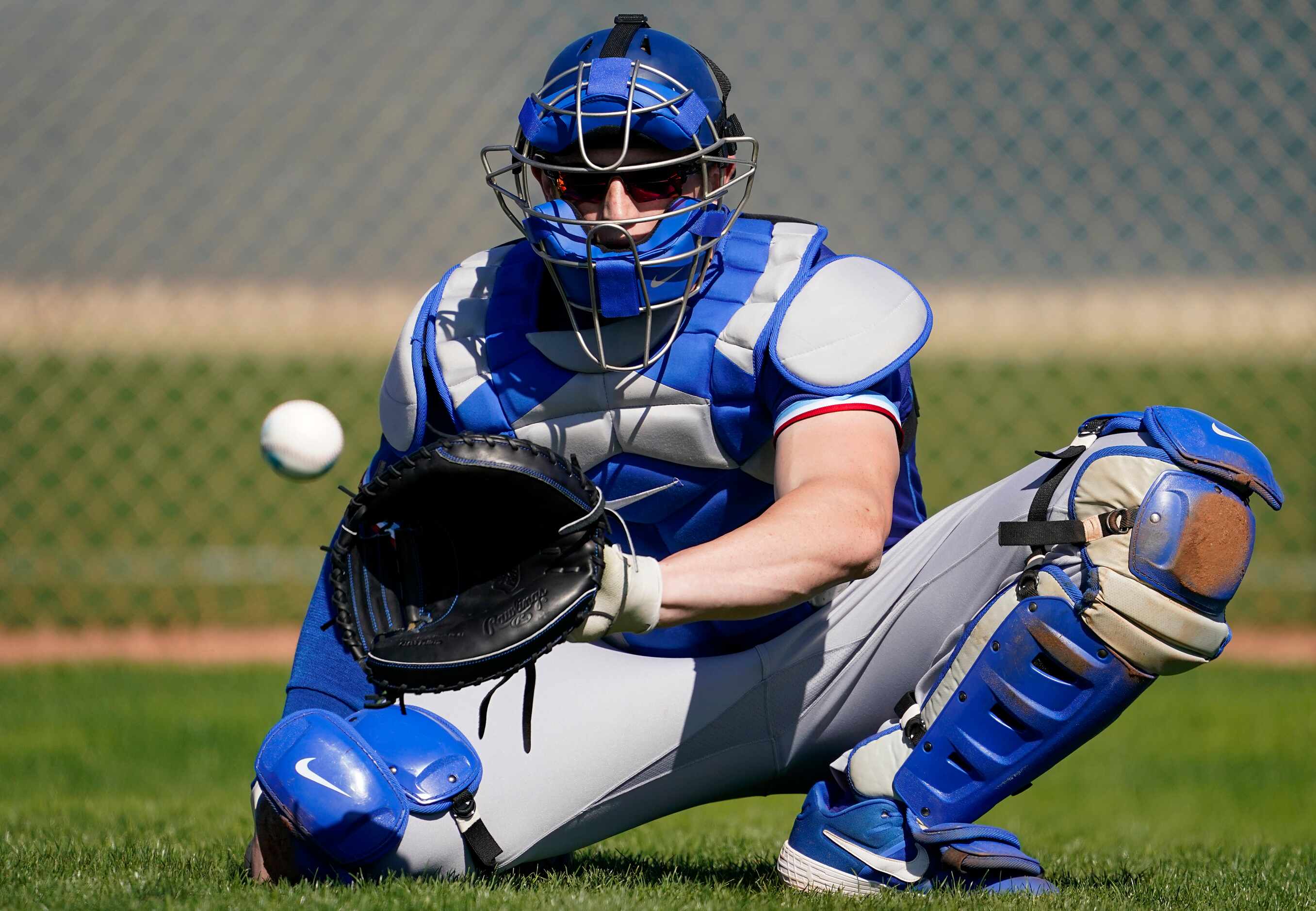 Texas Rangers catcher Sam Huff participates in a drill during the first spring training...