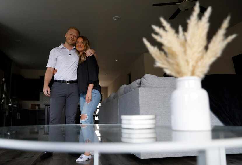 The couple recently purchased their first house, where the coffee table sits in the living...