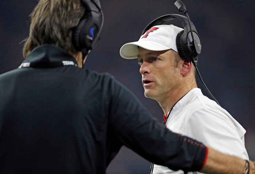 Texas Tech coach Matt Wells, right, talks to special teams coordinator Mark Tommerdahl...