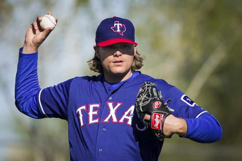 Texas Rangers pitcher A.J. Griffin participates in a fielding drill during a spring training...