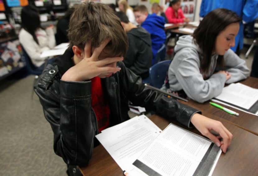 Jacob Sedgwick, 13, reads through an exercise in his English writing and language arts class...