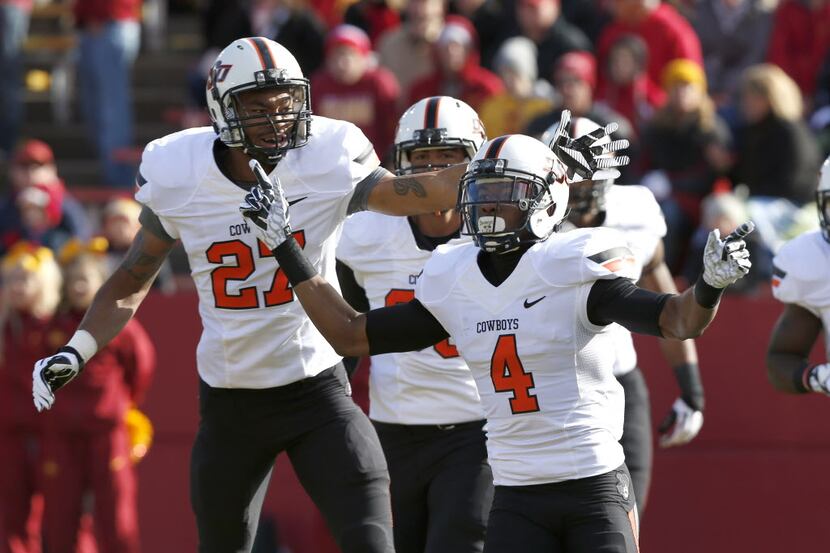 Cornerback Justin Gilbert #4 of the Oklahoma State Cowboys celebrates with teammate safety...
