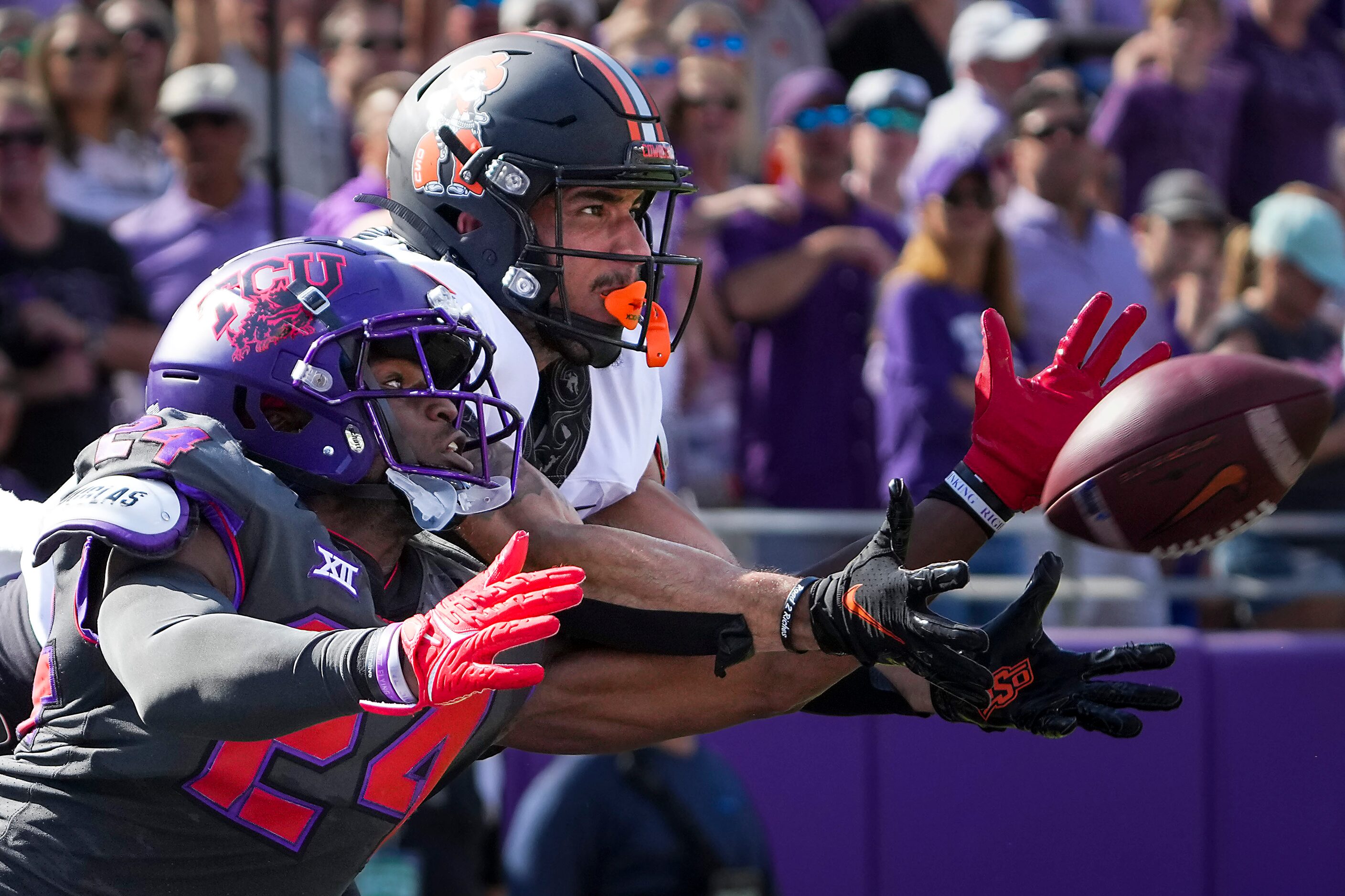 TCU cornerback Josh Newton (24) breaks up a pass intended for Oklahoma State wide receiver...