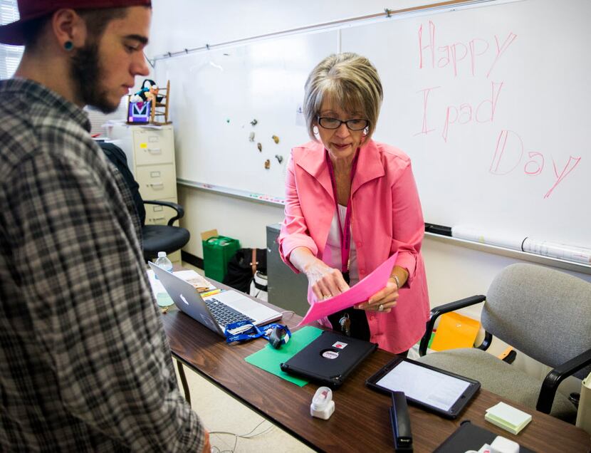 Dillan Akin works with campus technology specialist Vickie Dugan at Garland High School. As...