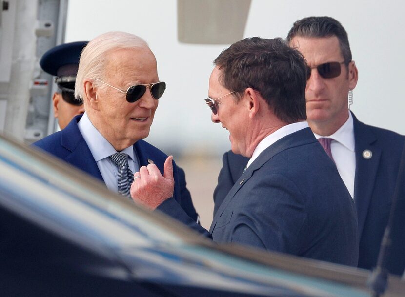 President Joe Biden, left, talks with Dallas County Judge Clay Lewis Jenkins upon his...