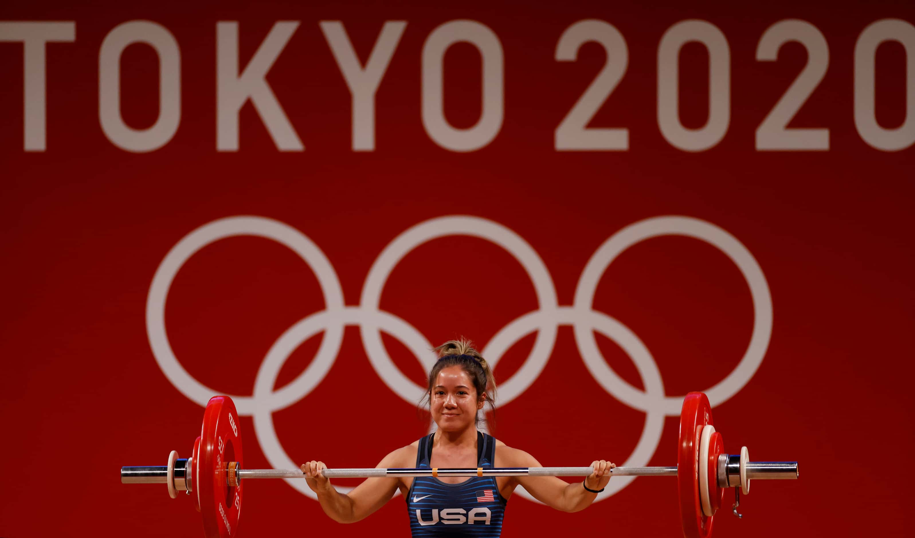 USA’s Jourdan Delacruz smiles after lifting 83 kg in the first attempt of the snatch round...