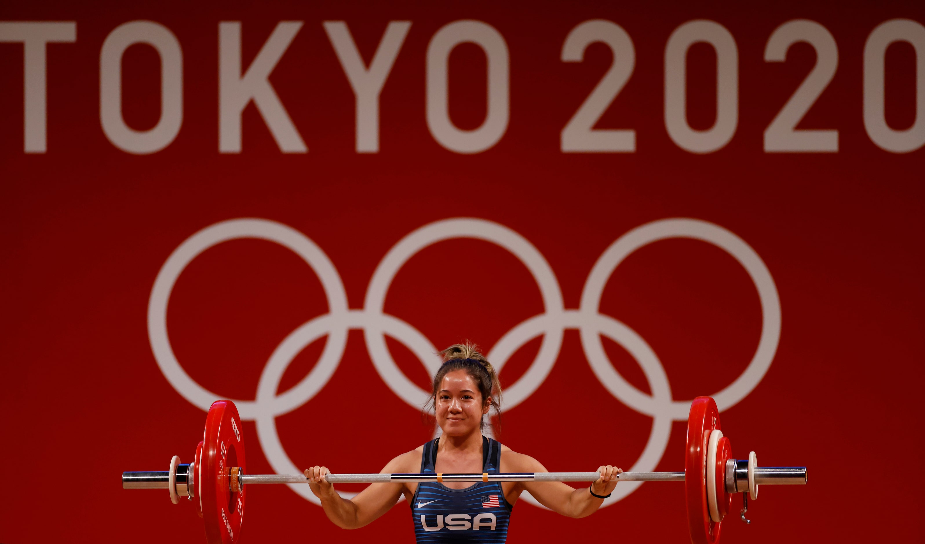 USA’s Jourdan Delacruz smiles after lifting 83 kg in the first attempt of the snatch round...