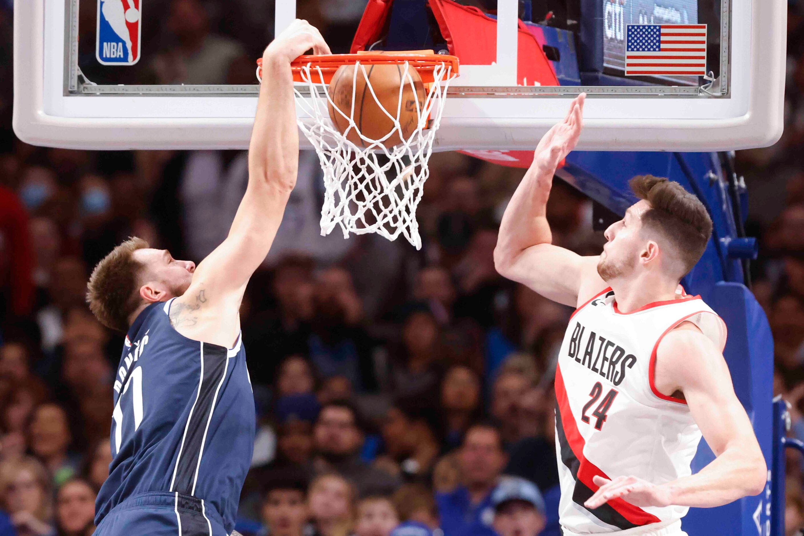 Dallas Mavericks guard Luka Doncic (77) dunks past Portland Trail Blazers forward Drew...