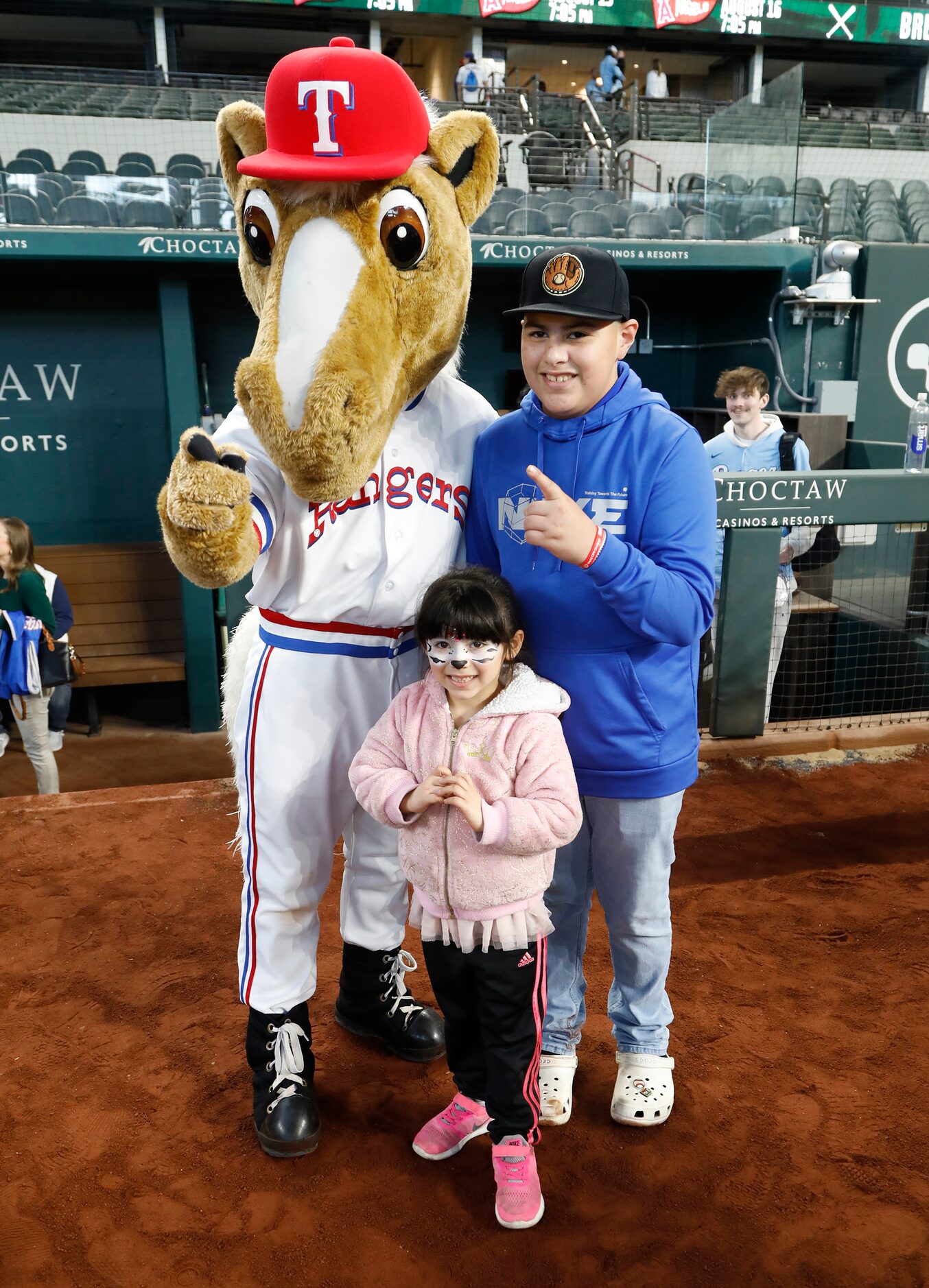 Isabel Arvizu (front), 5, of Arlington, poses with her brother Gabriel (right), 13, to get a...