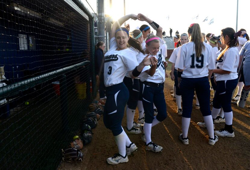 Flower Mound's Cierra Briggs (3) and Grace Meador (15) play around before a softball game...