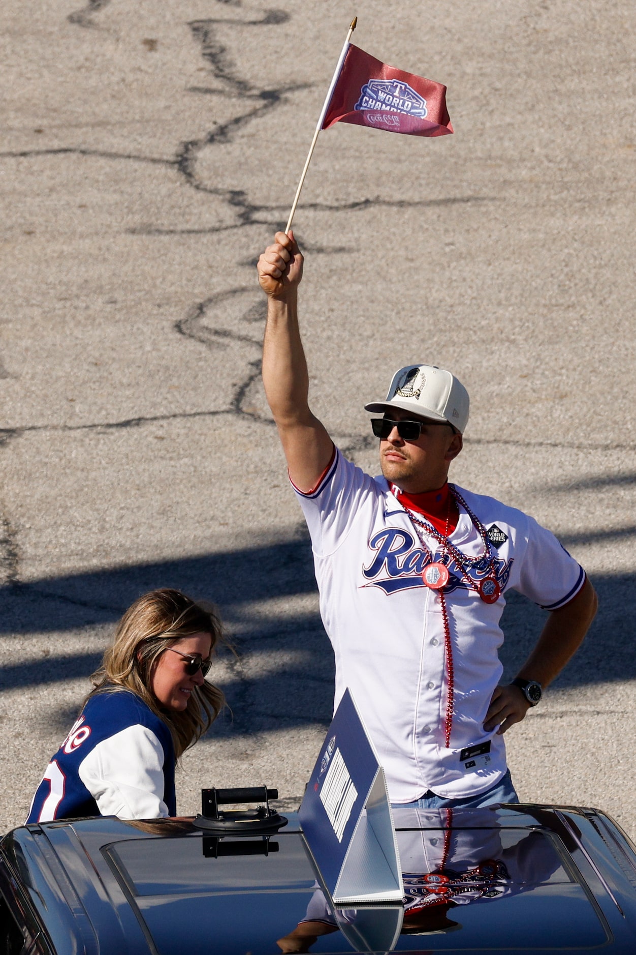 Texas Rangers first baseman Nathaniel Lowe holds up a World Series champions flag during the...