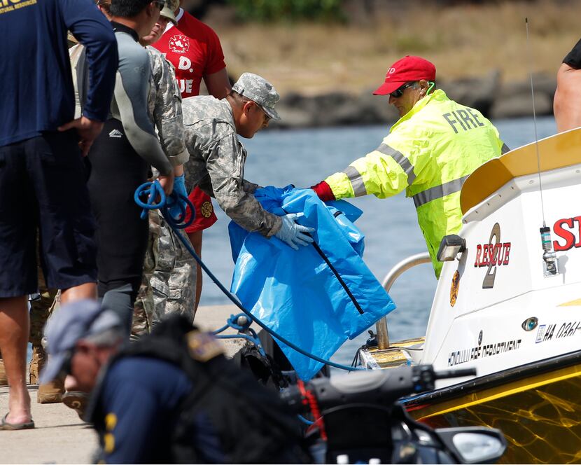 Water safety officials handed over possible crash debris Aug. 16 from an Army UH-60 Black...