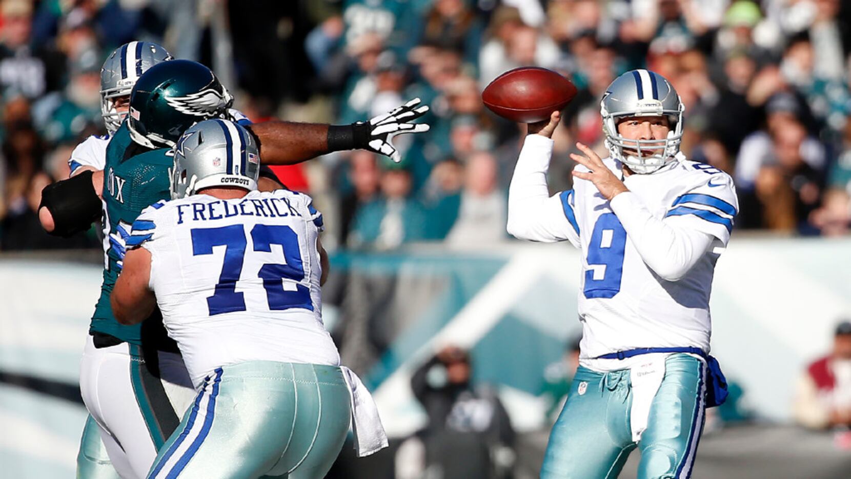 Dallas Cowboys quarterback Tony Romo (9) looks downfield to pass the ball against...