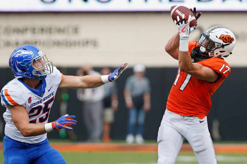 Oklahoma State wide receiver Dillon Stoner (17) catches a pass in front of Boise State...