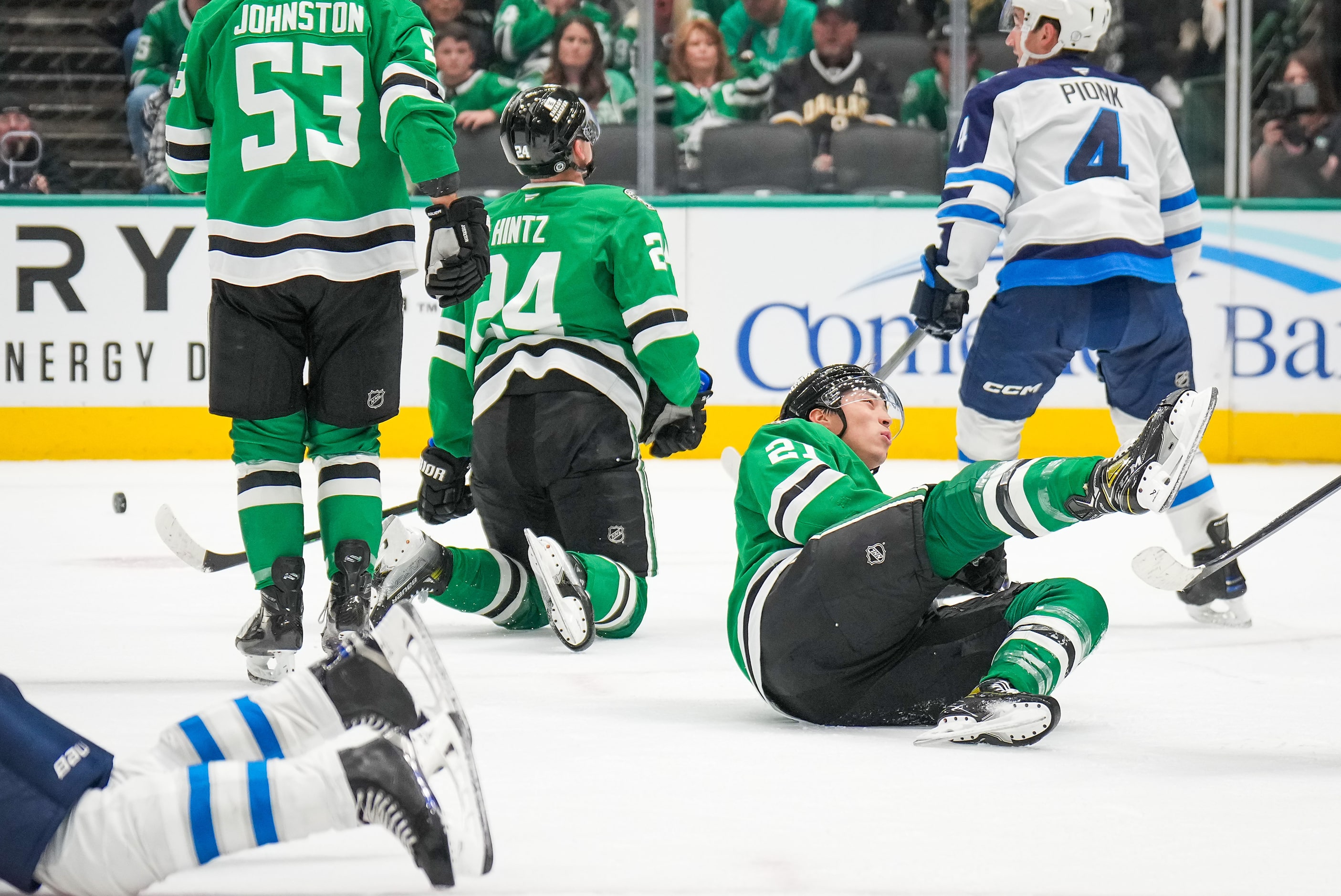 Dallas Stars left wing Jason Robertson (21) tumbles to the ice during the first period of an...