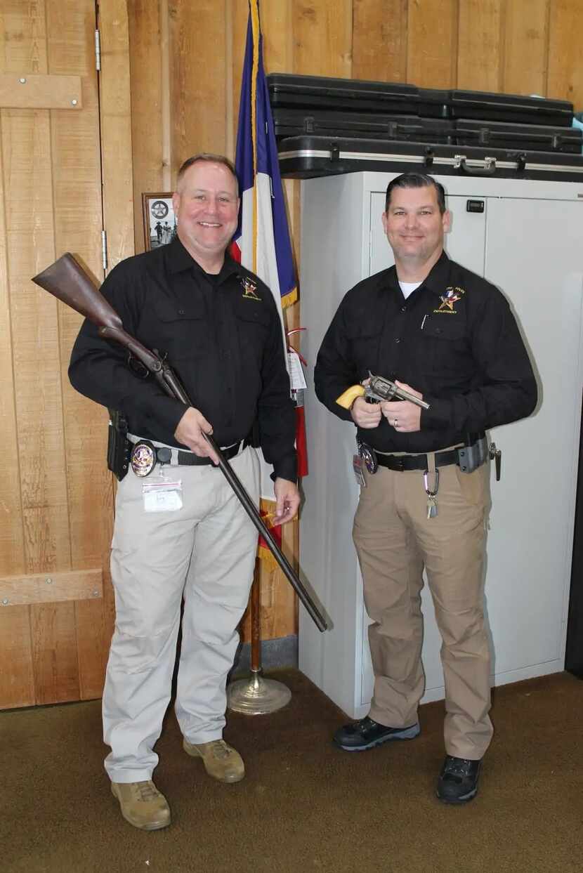 DeSoto police officers Sergeant Williams and Corporal Ziegler hold the two donated...