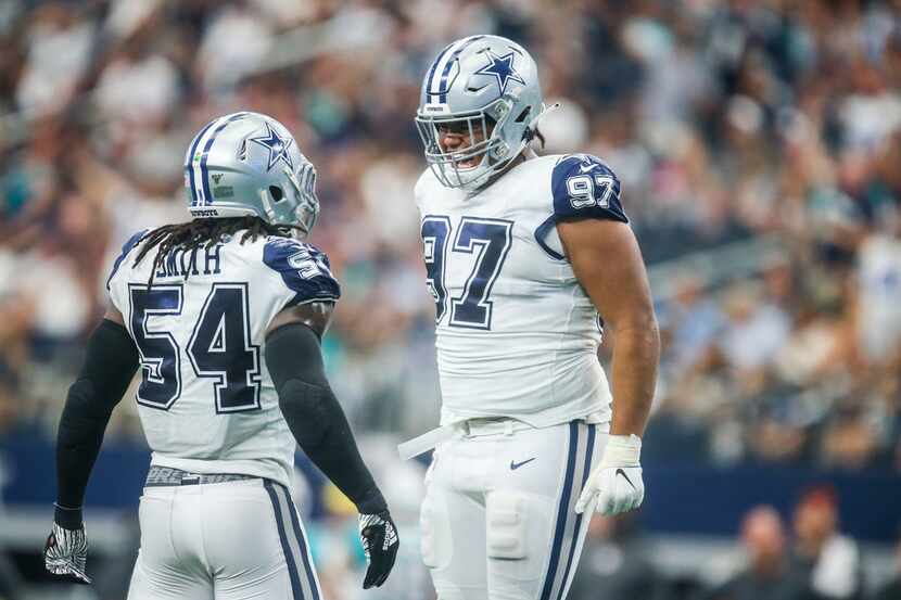 Dallas Cowboys middle linebacker Jaylon Smith (54) celebrates with defensive tackle Trysten...