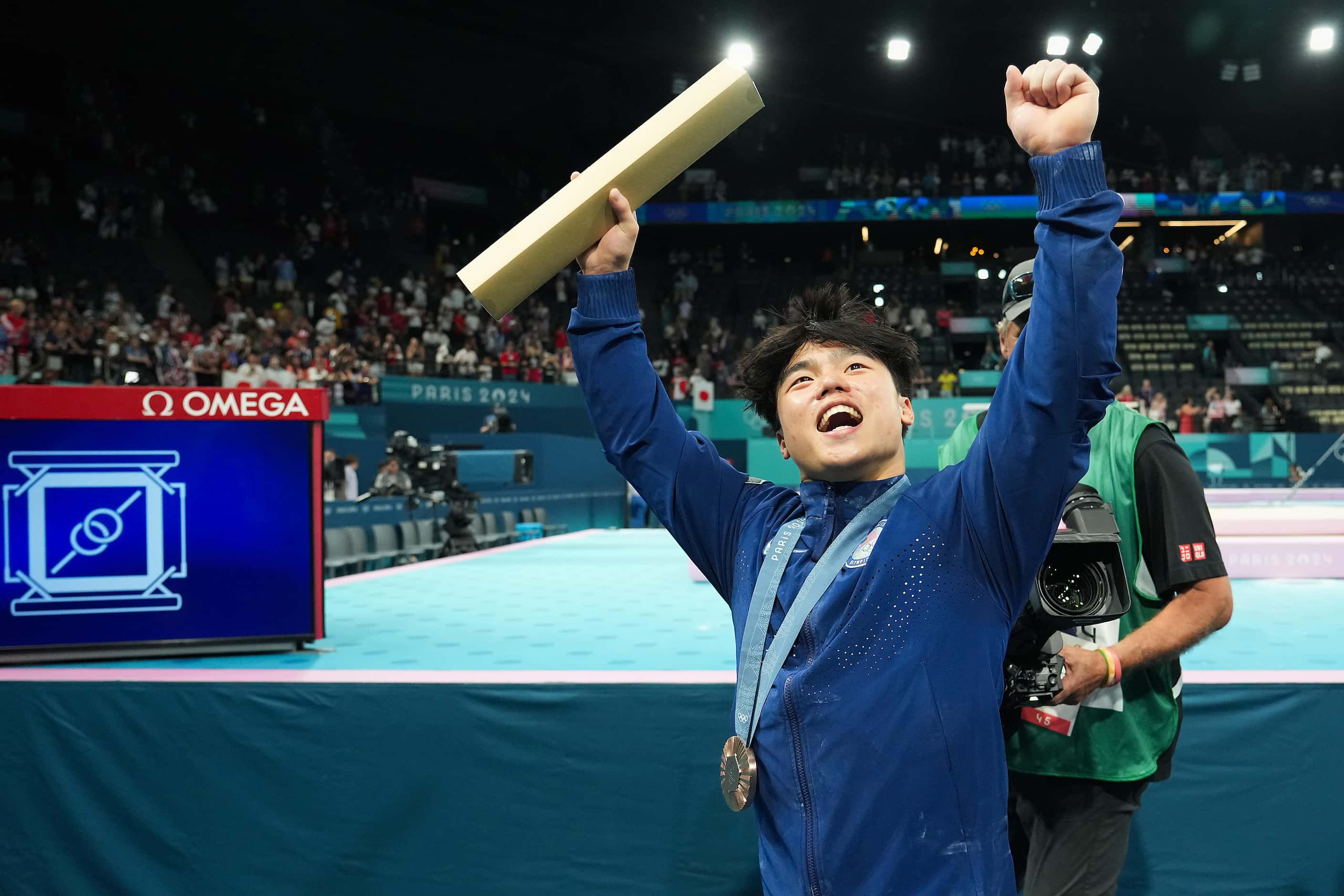 Asher Hong of the United States waves waves to the crowd as he leave the floor after winning...