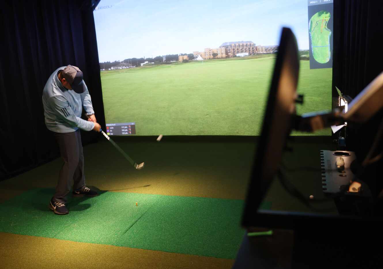 Jay Bivin plays virtual golf in one of five simulators at Daylight Golf on Thursday, January...