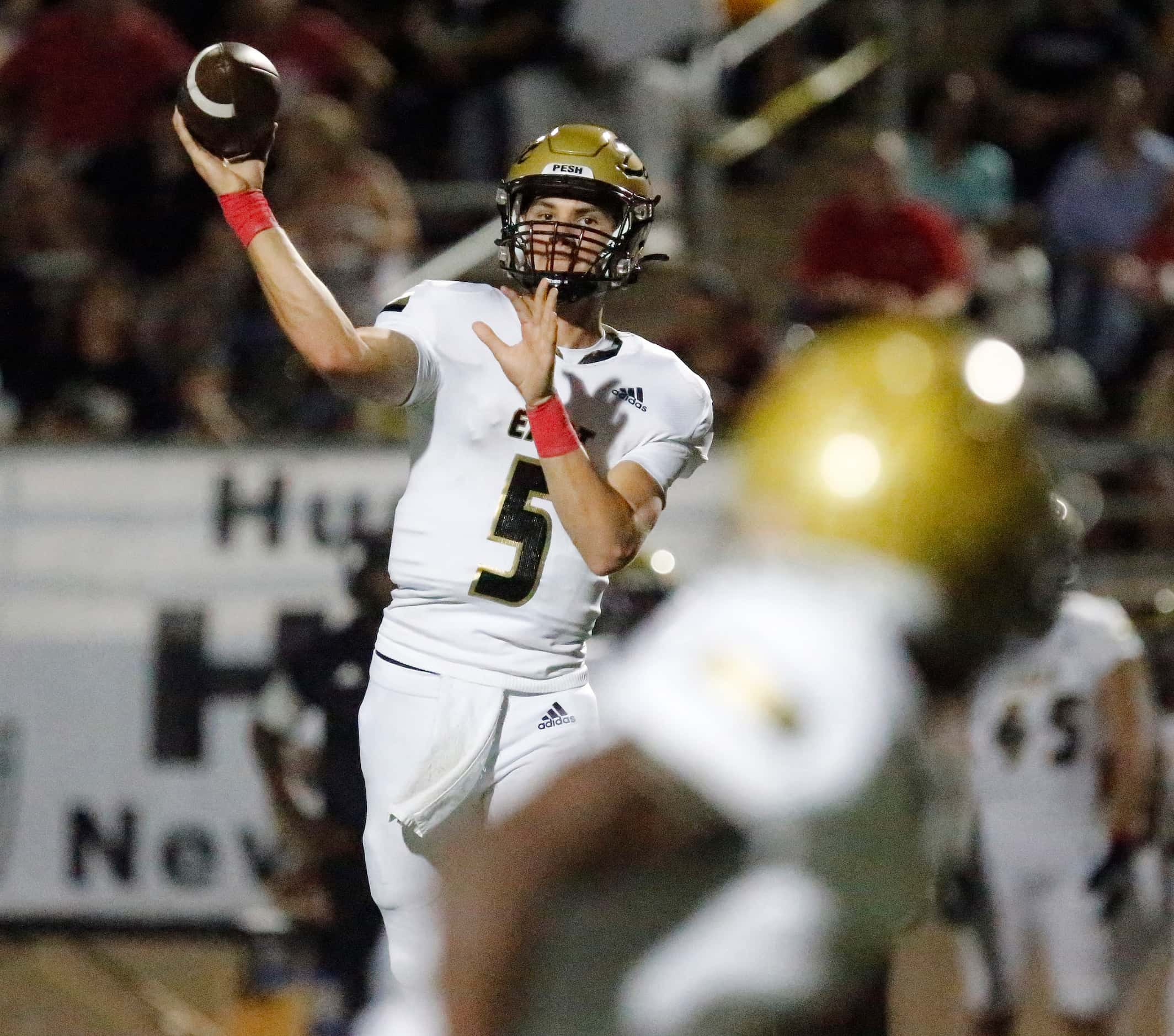 Plano East High School quarterback Drew Devillier (5) during the first half as Plano High...