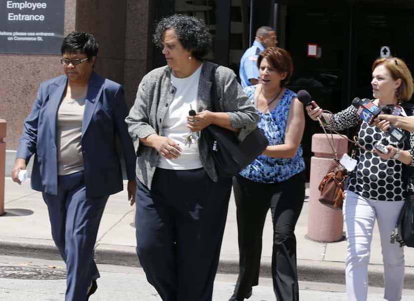Kathy Nealy (left) leaves the federal courthouse in Dallas in 2014 after being indicted on...