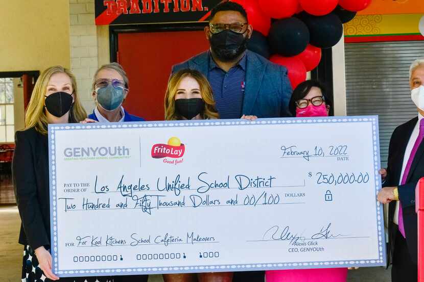 Representatives from GENYOUth and Frito-Lay hold a check donated to the LAUSD for $250,000.