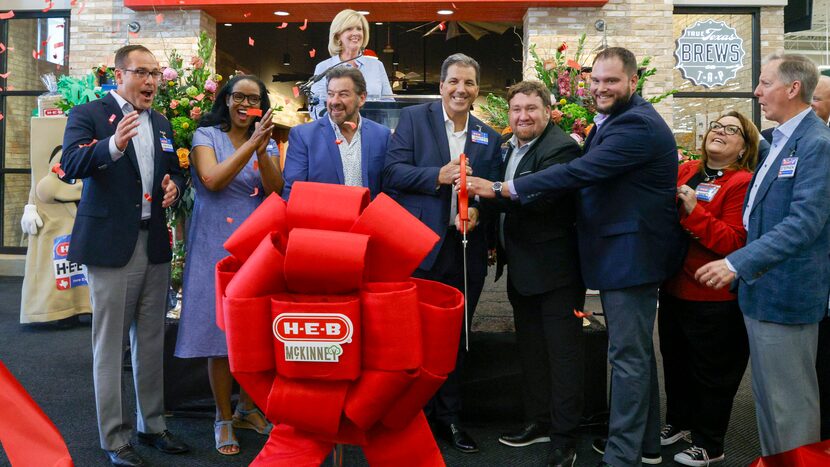 Representatives from H-E-B alongside McKinney Mayor George Fuller (third from left)...